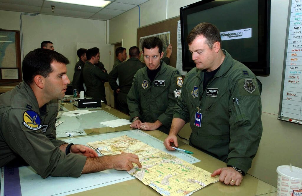 Pilots discuss flight plans prior to a mission in support of Exercise RED FLAG 2002